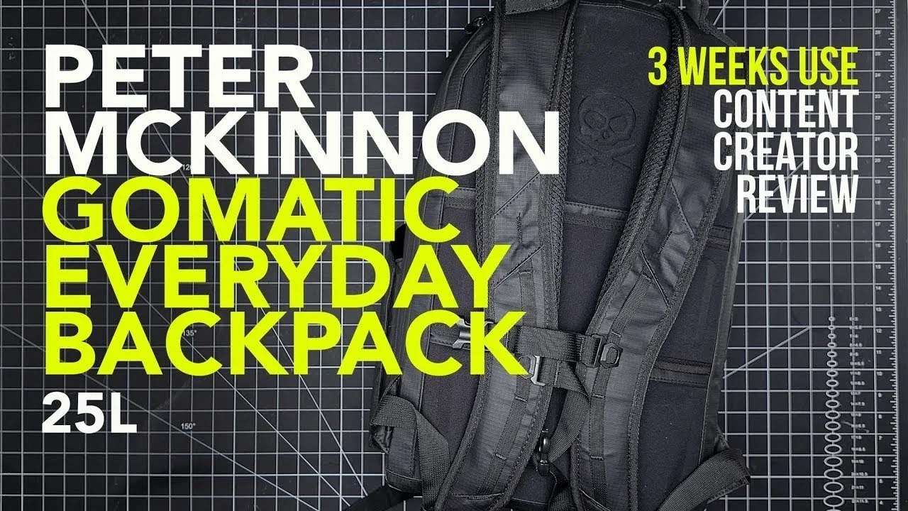 A black backpack with a skull logo on the top front pocket, placed on a grid-patterned background. Text overlay on the image reads, 'Peter McKinnon Gomatic Everyday Backpack 2.5L' and '3 Weeks Use Content Creator Review' in large white and yellow let