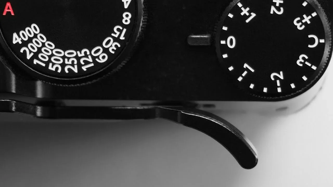 Close-up of a vintage camera showing the dials and controls, with a focus on the top section.