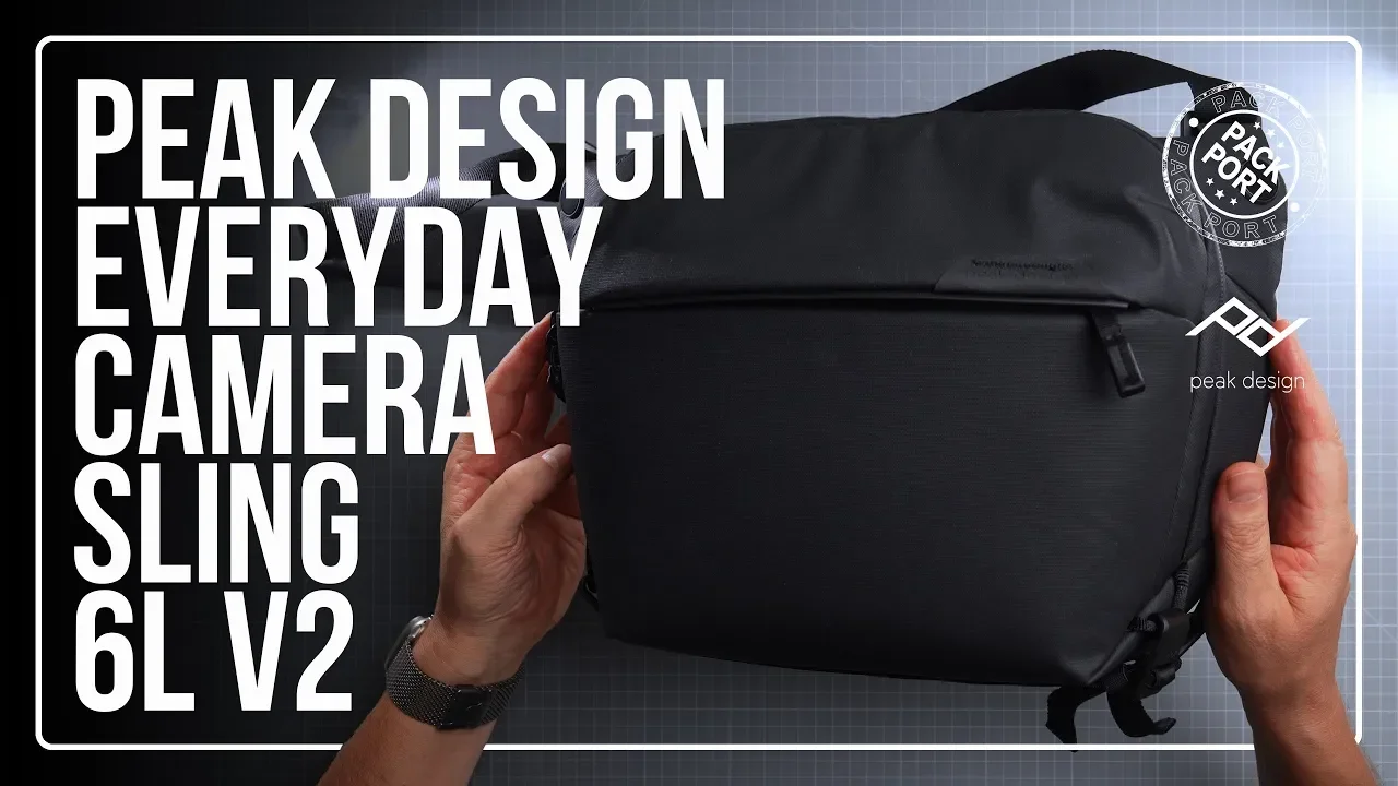 Person holding a black Peak Design Everyday Camera Sling 6L V2 bag against a backdrop with branding and text.