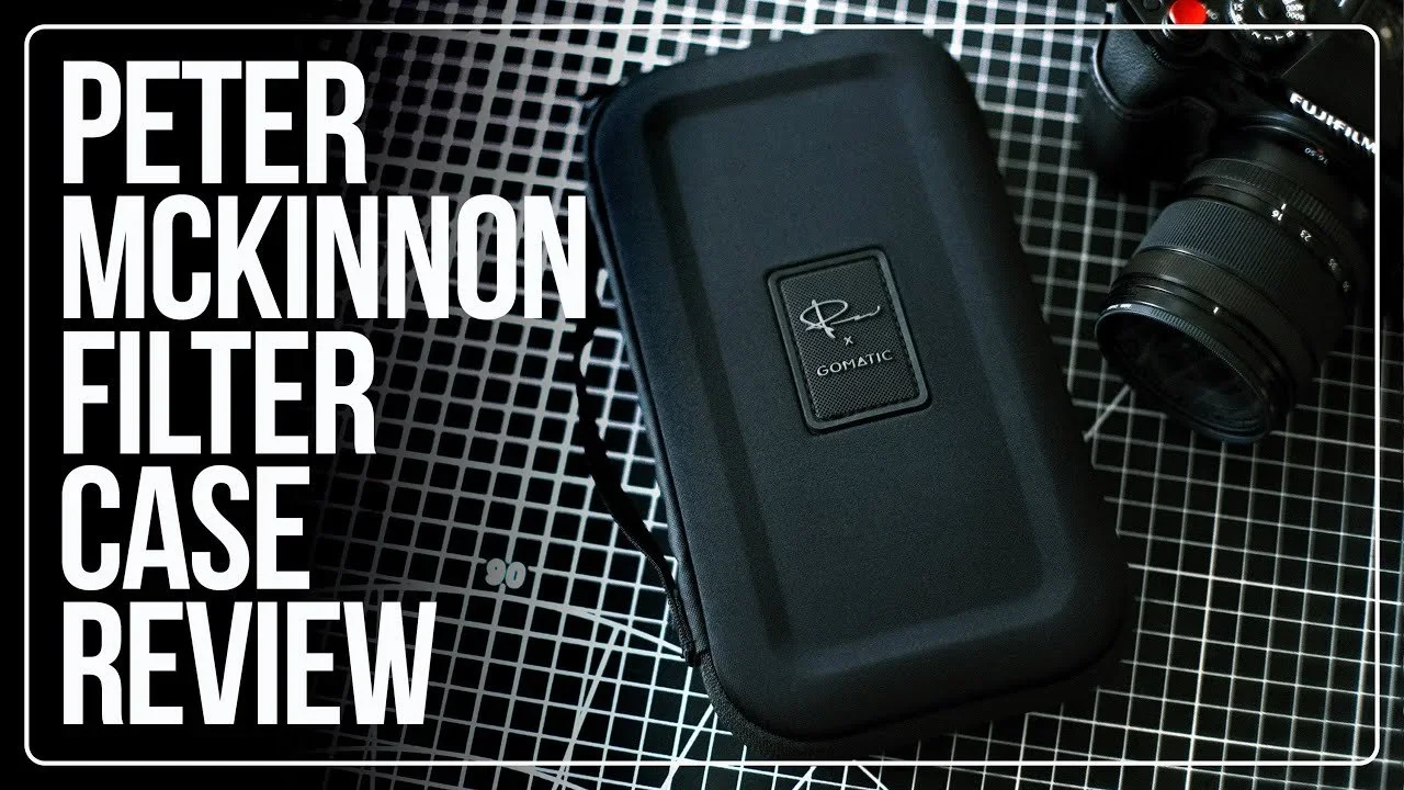 Close-up photo of a GOMATIC filter case with a camera lens beside it, placed on a black-and-white grid-patterned surface, with a text overlay that reads 'Peter McKinnon Filter Case Review'.