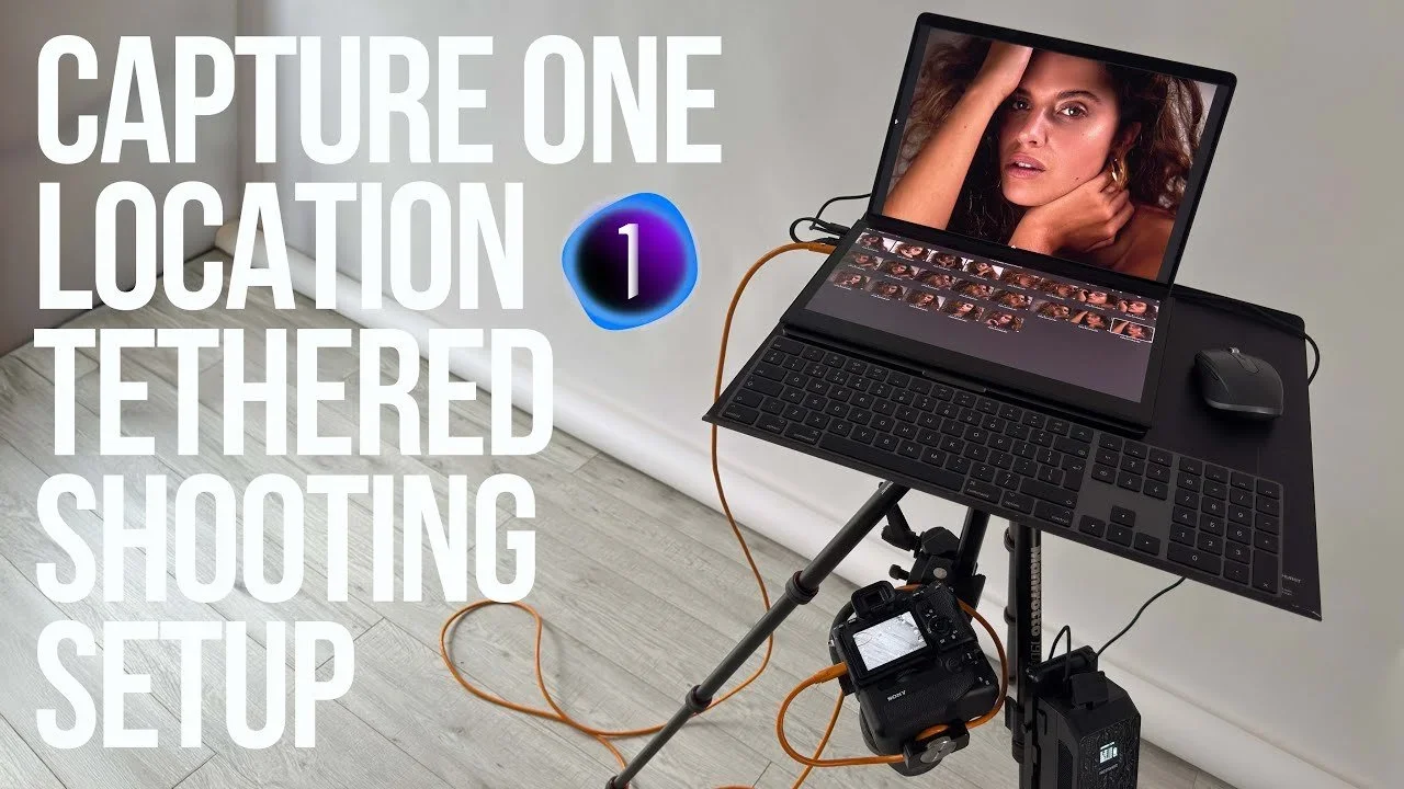 Photography setup with a laptop, camera, and camera accessories for tethered shooting, displaying a woman on the laptop screen, against a light-colored wall and wooden floor.