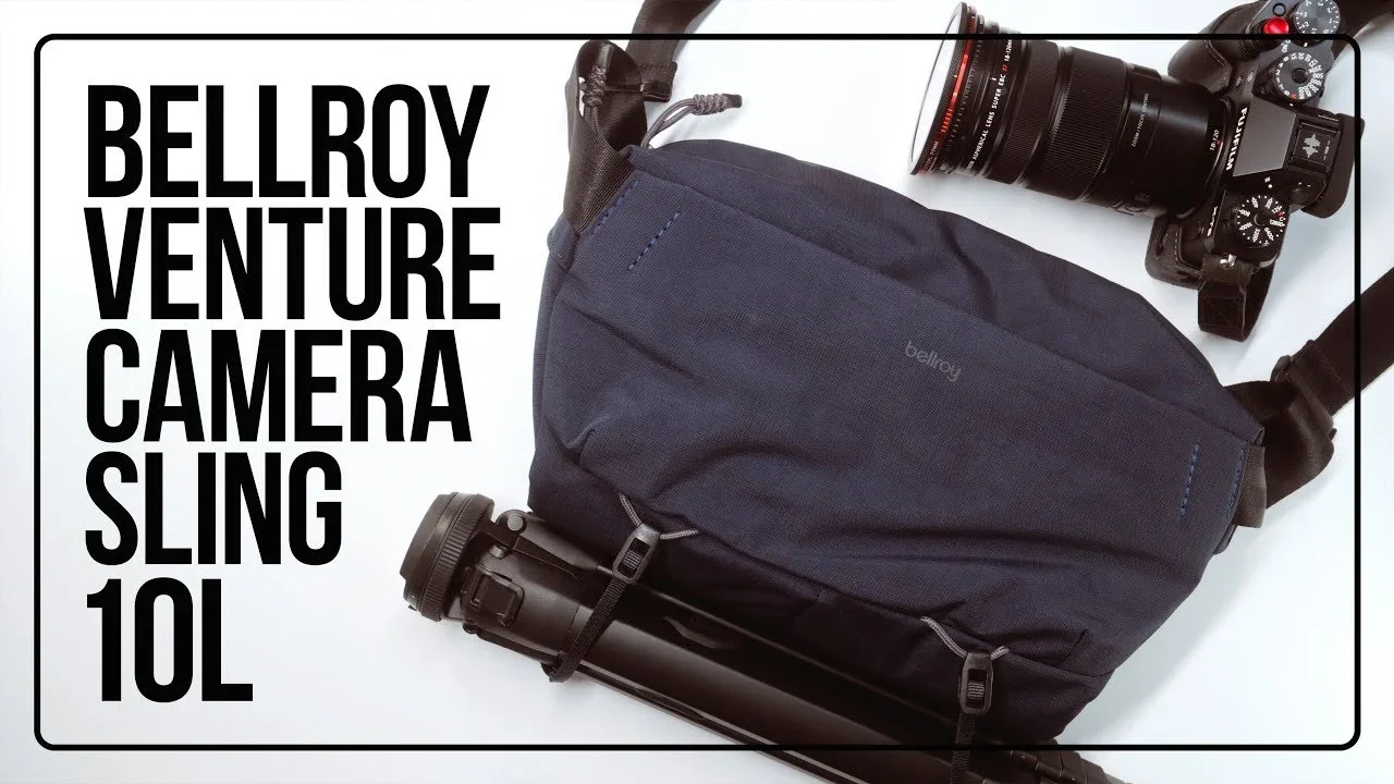 A camera sling bag with a camera and lens and a water bottle placed beside it, with text overlay reading 'Bellroy Venture Camera Sling 10L' on a white background.