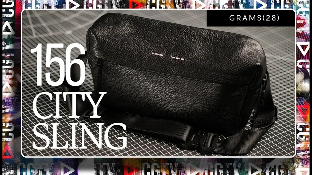 A black leather shoulder bag on a textured surface with colorful TV show logos in the background, featuring text "156 CITY SLING" and "GRAMS(28)".