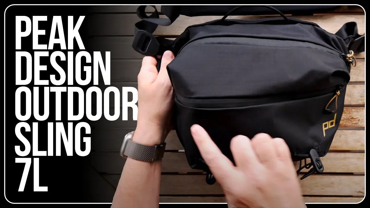 A person holding a black outdoor sling bag with a zipper, on a wooden surface, with white text on the image stating "PEAK DESIGN OUTDOOR SLING 7L".