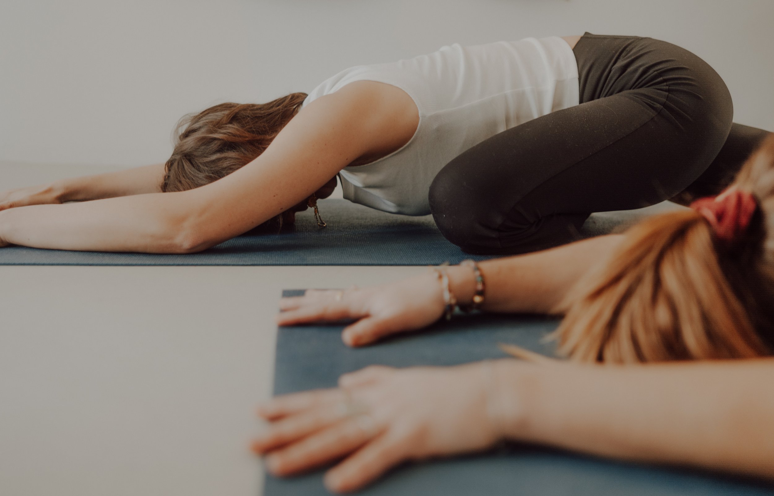 Person in Kinderposition während Yoga-Übung auf Yogamatte, Nahaufnahme