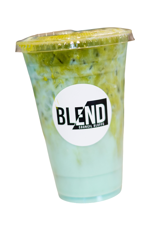 A plastic cup with a clear lid containing a green and white layered smoothie or drink, with a round logo on the front that says 'BLEND COUNCIL BLUFFS'.