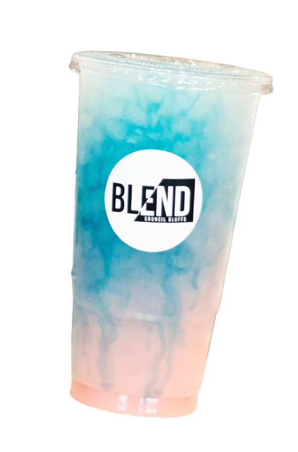 A large iced beverage in a clear plastic cup with a domed lid, featuring a blue and pink swirl pattern and a black and white 'BLEND Council Bluffs' logo on the front.