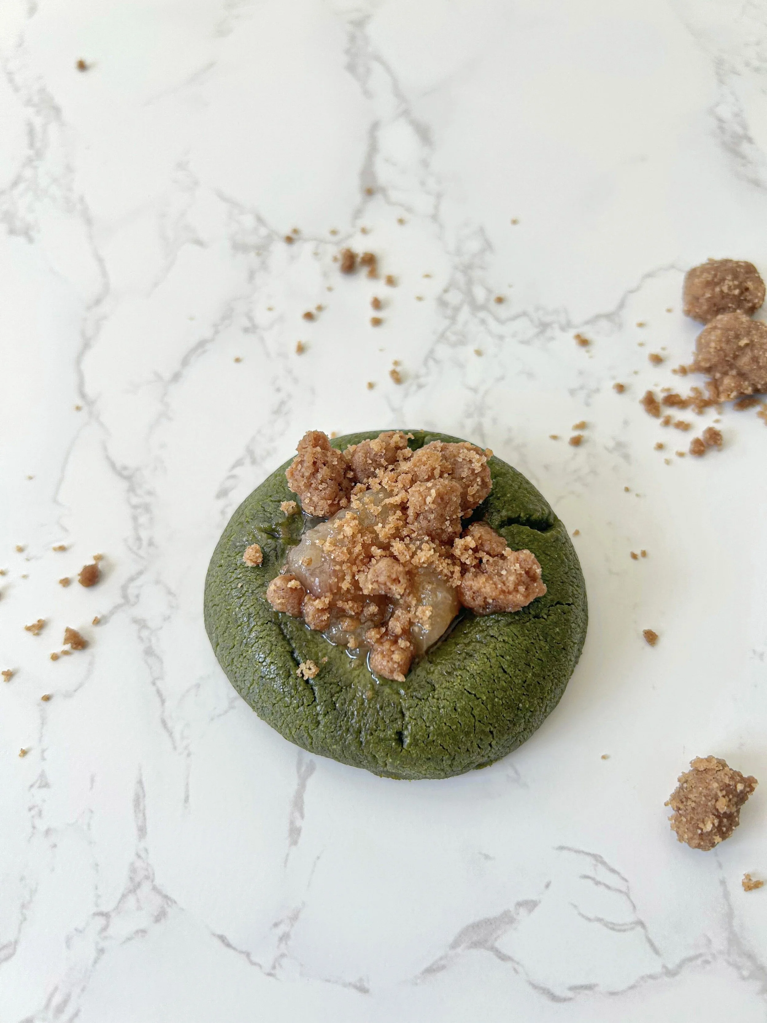 Matcha peach cookie topped with cinnamon crumble made with ceremonial-grade matcha from a Singapore matcha bakery.