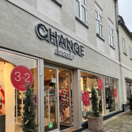 Outside of a lingerie store named 'Change Lingerie' with Christmas decorations and sale signs in the windows.