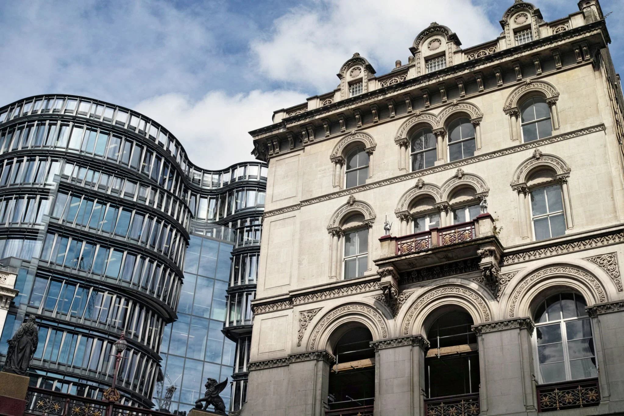 A juxtaposition of historic and modern architecture with a contemporary glass building.