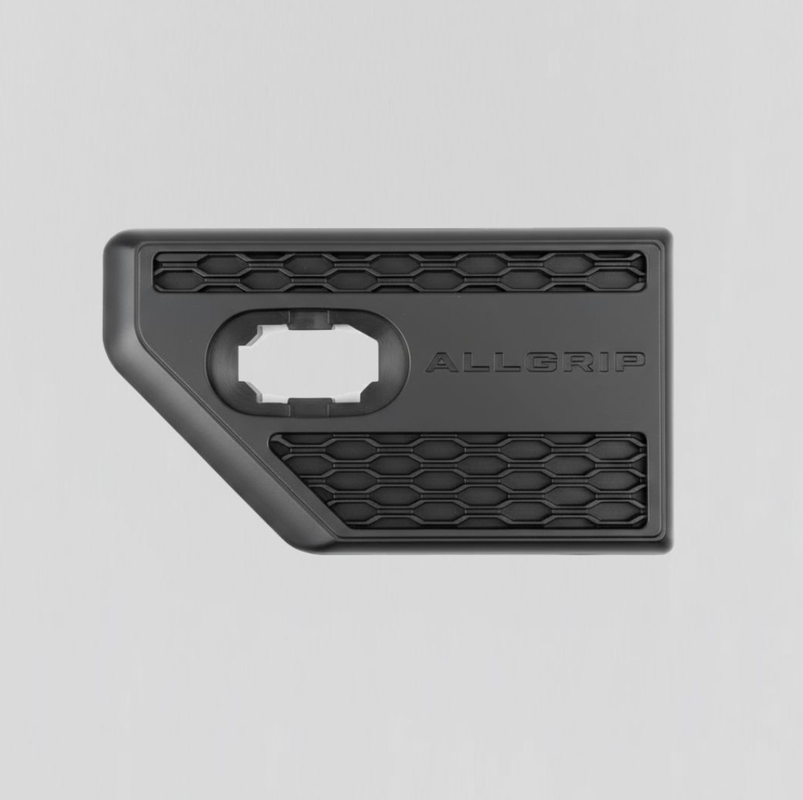 Close-up of a black plastic product with a textured, honeycomb pattern and the brand name 'ALLGRIP' embossed on it, with a circular opening on one side.