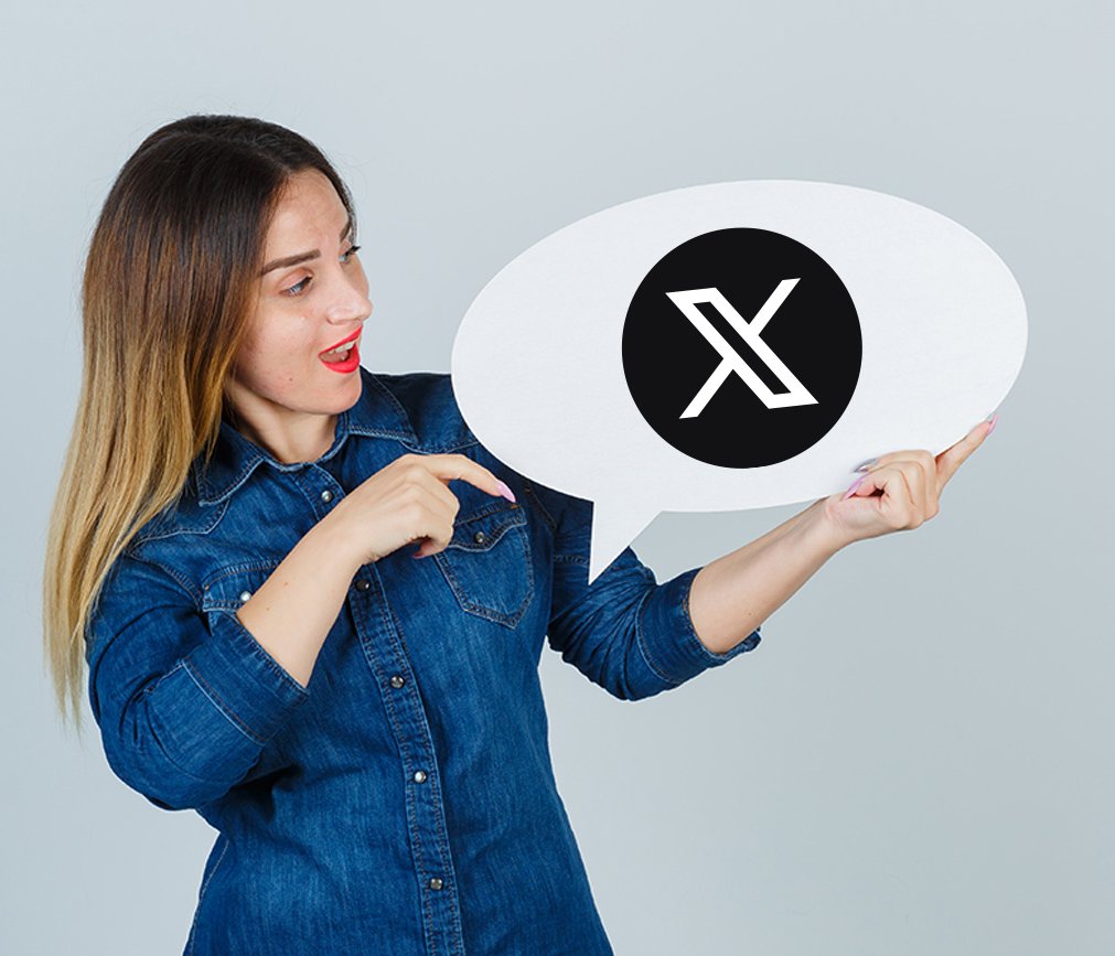 A woman holding a speech bubble with a canceled or crossed-out icon.