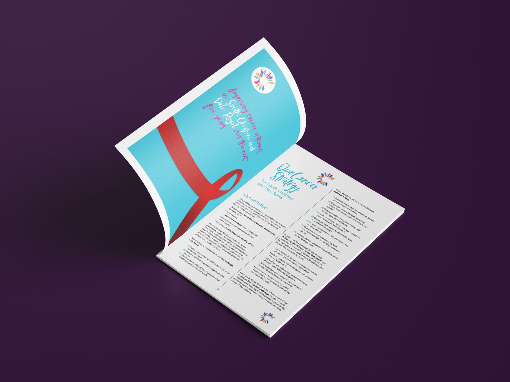 Open booklet with information about cancer strategy, placed on a dark purple surface.