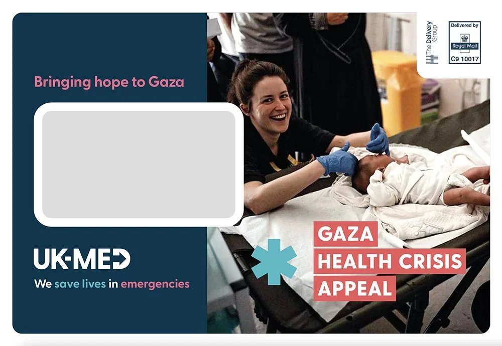 A smiling woman in blue gloves smiling at a newborn baby lying on a hospital bed, with medical staff in the background. The image is part of a Gaza health crisis appeal by UK-Med with text 'Bringing hope to Gaza' and 'We save lives in emergencies.'