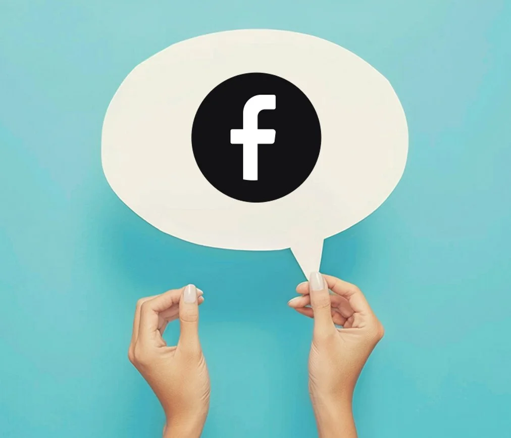 Person holding a speech bubble with the Facebook logo on a blue background.