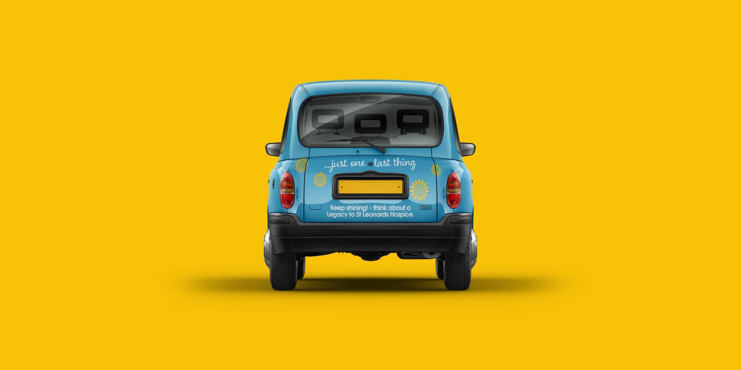 Rear view of a small blue car with yellow and white promotional text and graphics, placed on a yellow background.