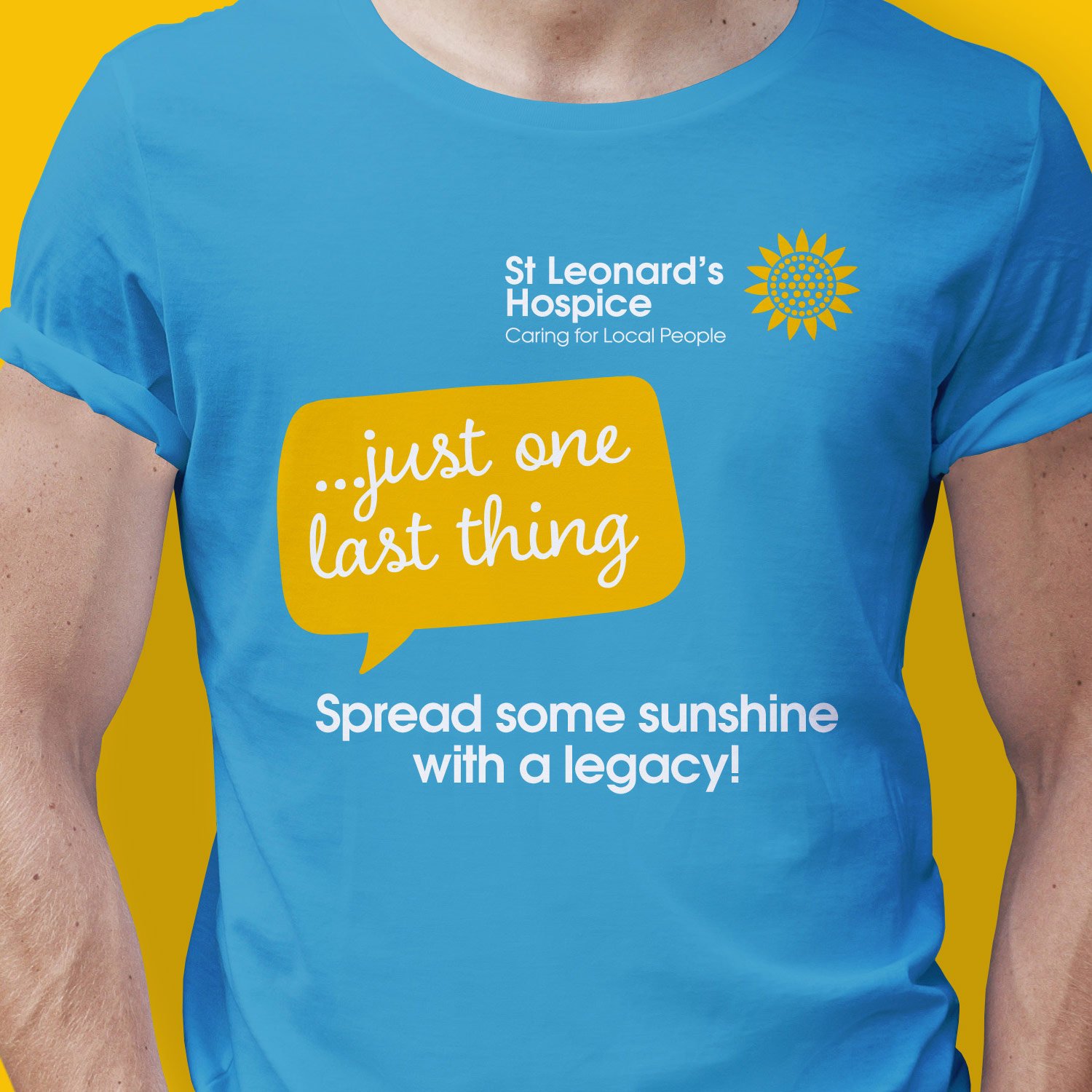 A person wearing a blue T-shirt with the logo of St. Leonard's Hospice and messages promoting kindness and legacy, with a yellow background.