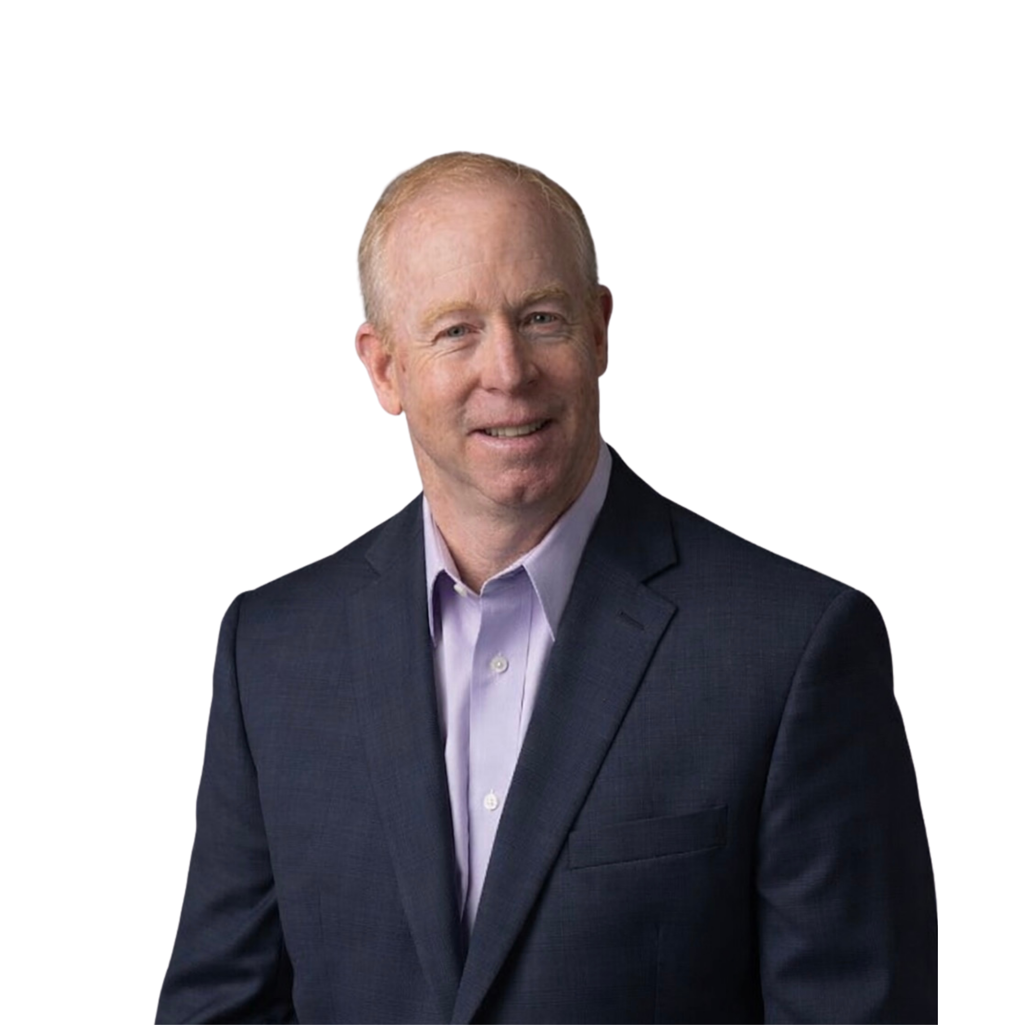 A middle-aged man with light skin, short light hair, dressed in a navy suit and light purple shirt, smiling and looking at the camera against a black background.