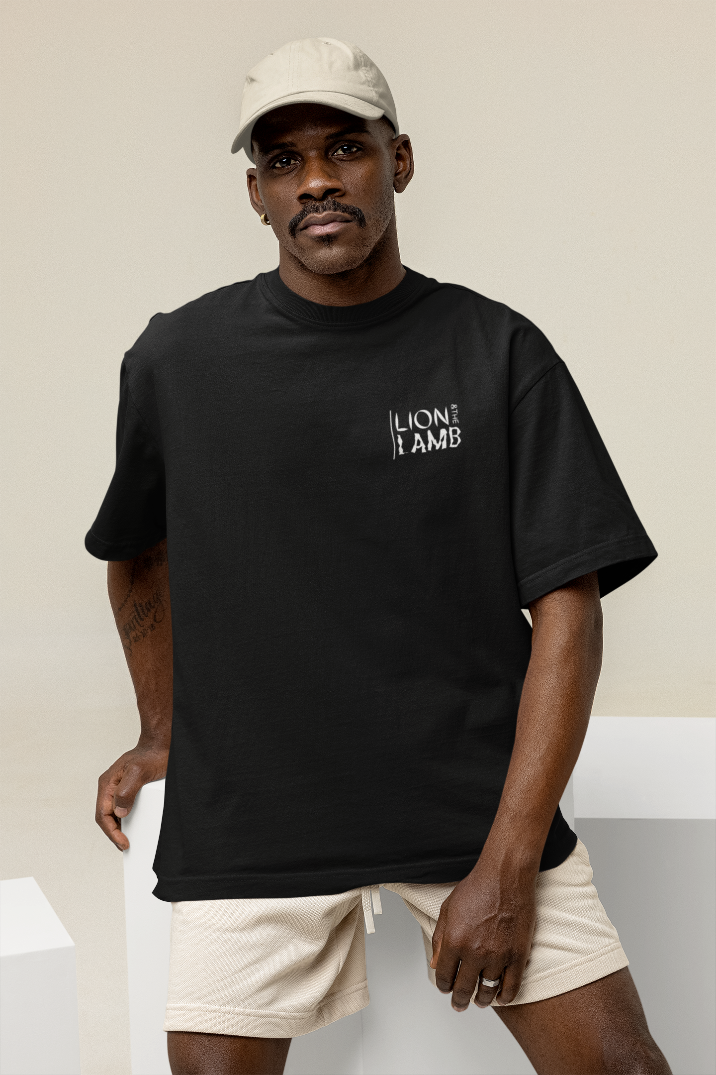 mockup-of-a-serious-man-wearing-an-oversized-tee-and-a-dad-hat-at-a-studio-m26647.png