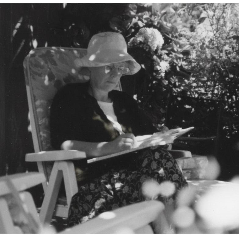Portrait of Elizabeth Laird writing outdoors in a garden setting, Ethiopia.