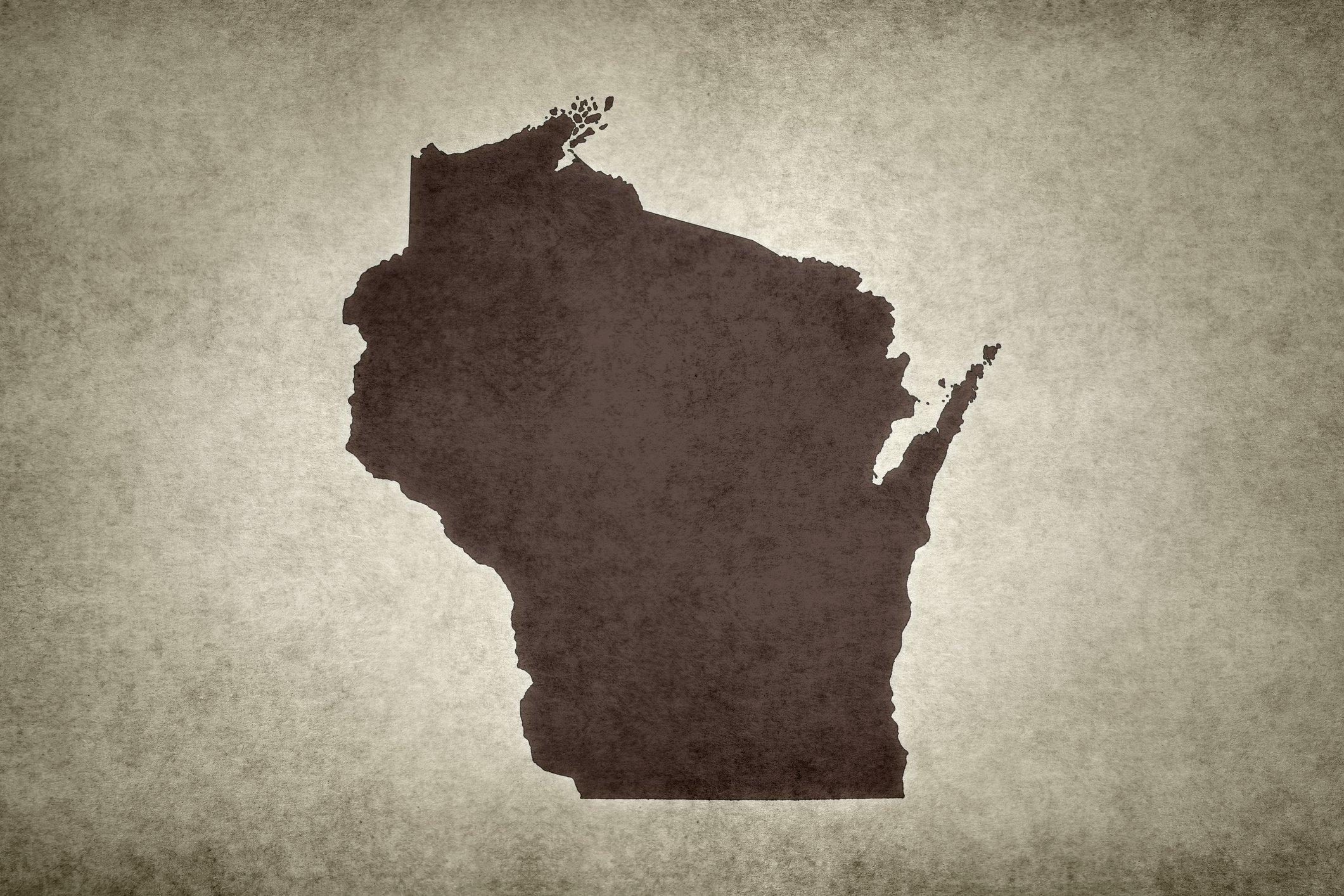 Silhouette of the state of Wyoming on a textured background.