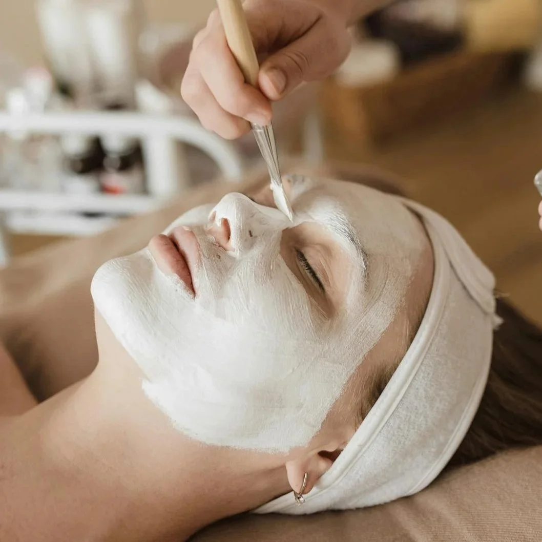 Esthetician applying a chemical peel solution to a client's face for skin renewal at Silk Skin & Wellness in Woodbridge, VA