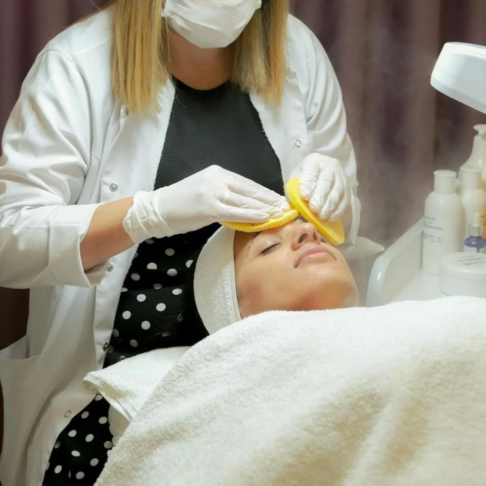Esthetician performing a deep cleansing facial on a client at Silk Skin & Wellness in Woodbridge, VA