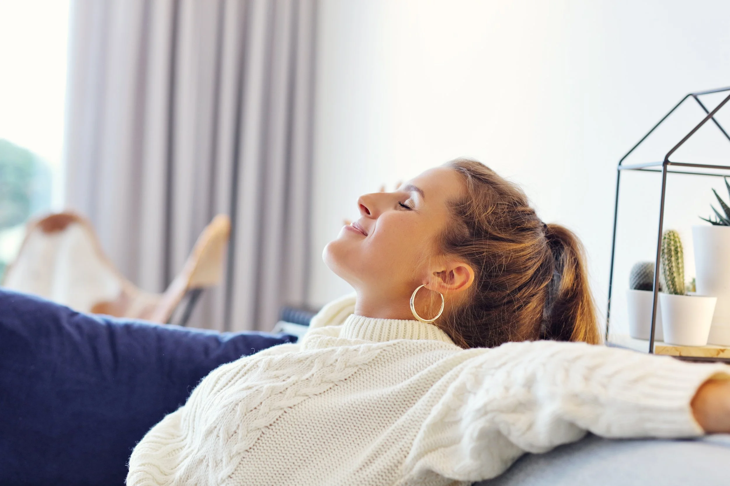 adult woman happily relaxing at their home