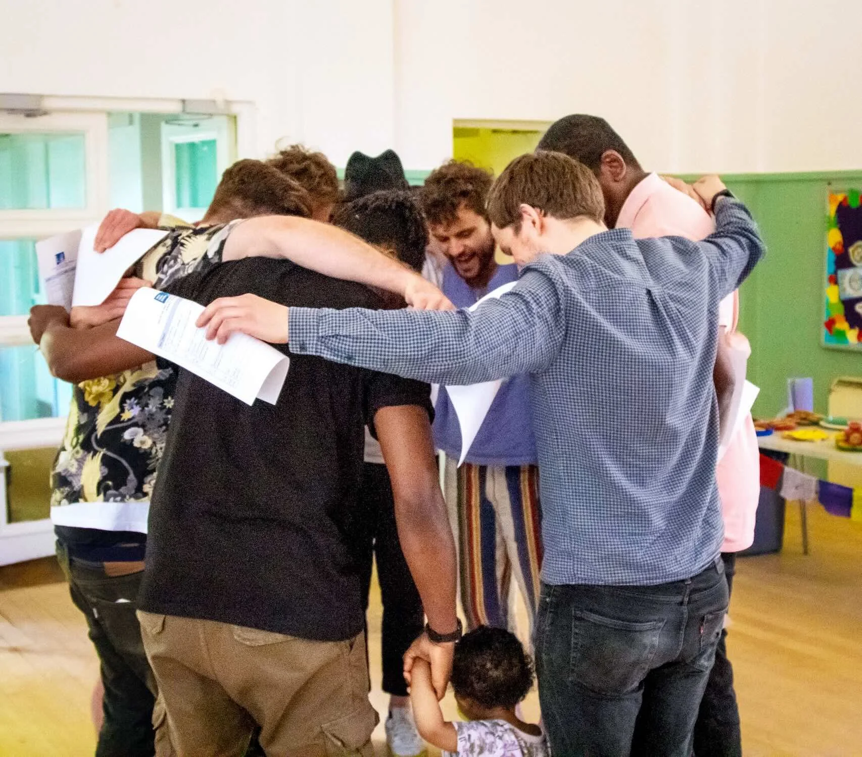 Father Figures Showcase - Huddle participants gather up in a circle