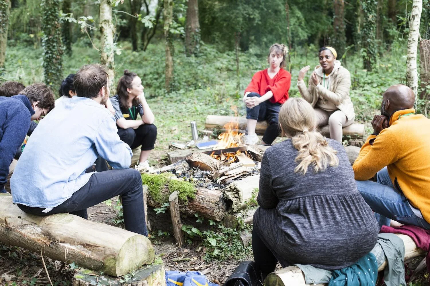 Huddle Camp - Peers chatting by the fire - photo by Ruth Davey