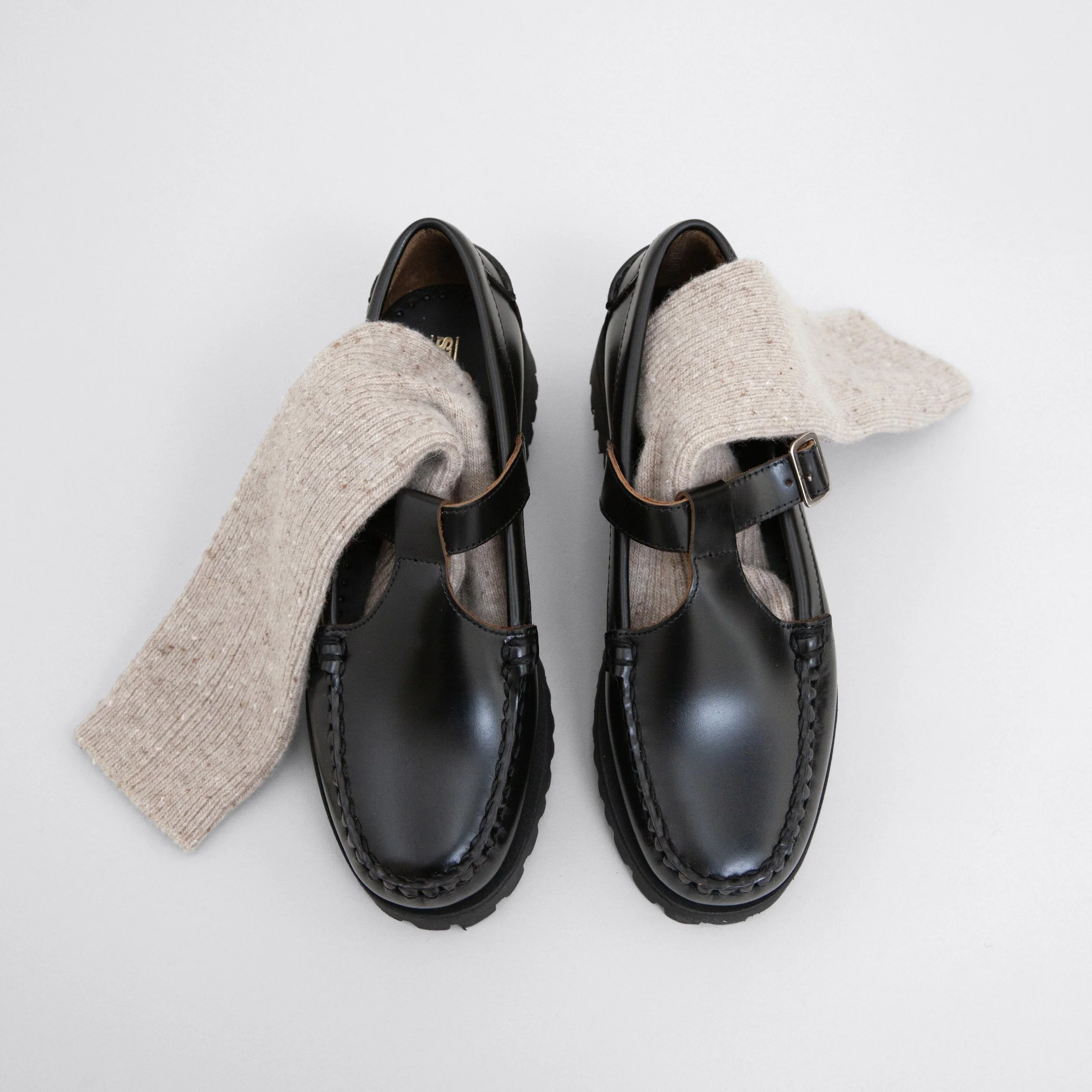 Still life photography of leather shoes with socks from le bon shoppe