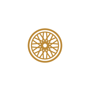 A gold-colored wheel or circular design with intricate patterns on a white background.