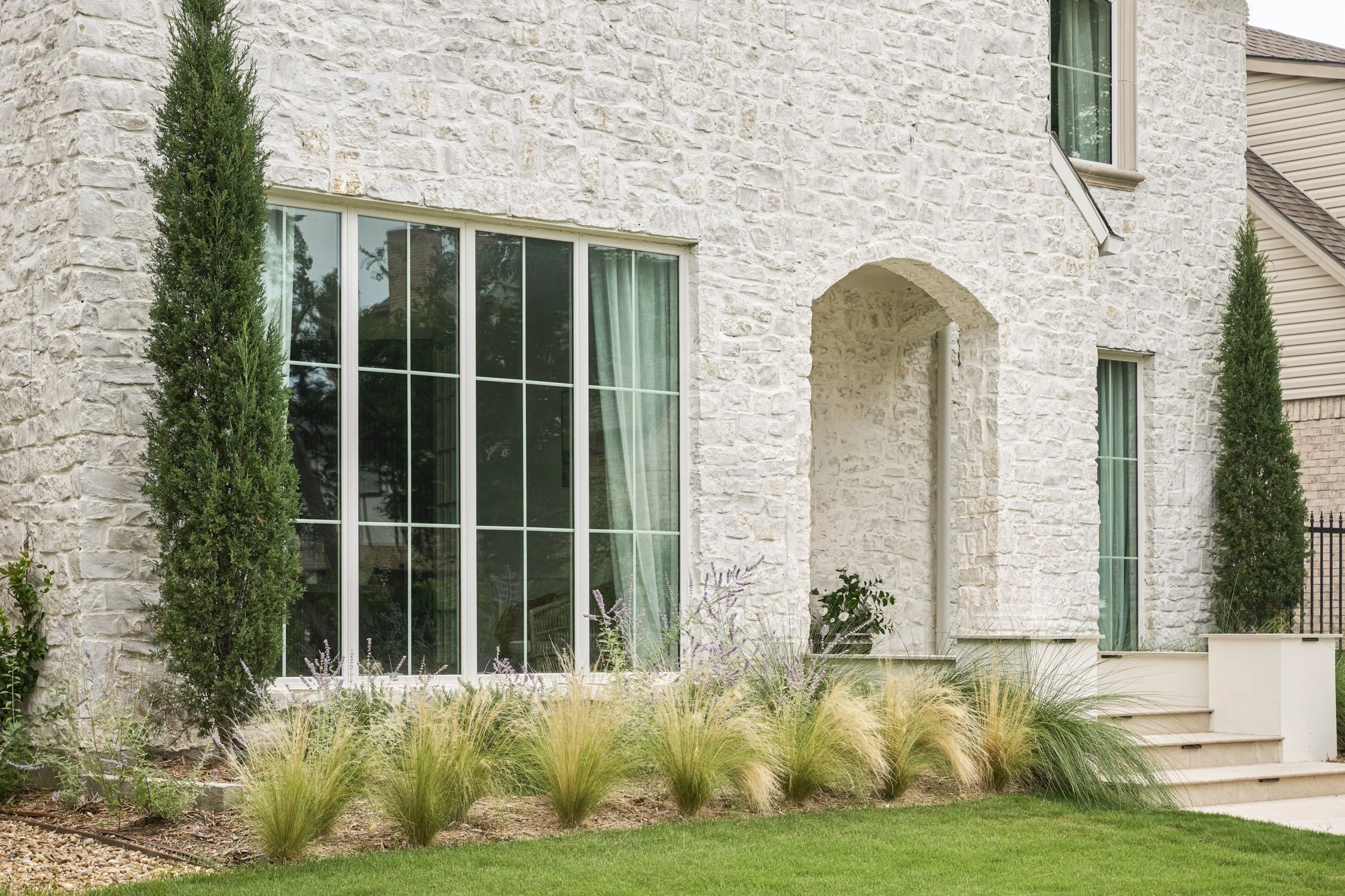 California-inspired front yard landscape with layered Ornamental Grasses in Dallas, TX | Designed by Caroline Higgins Design
