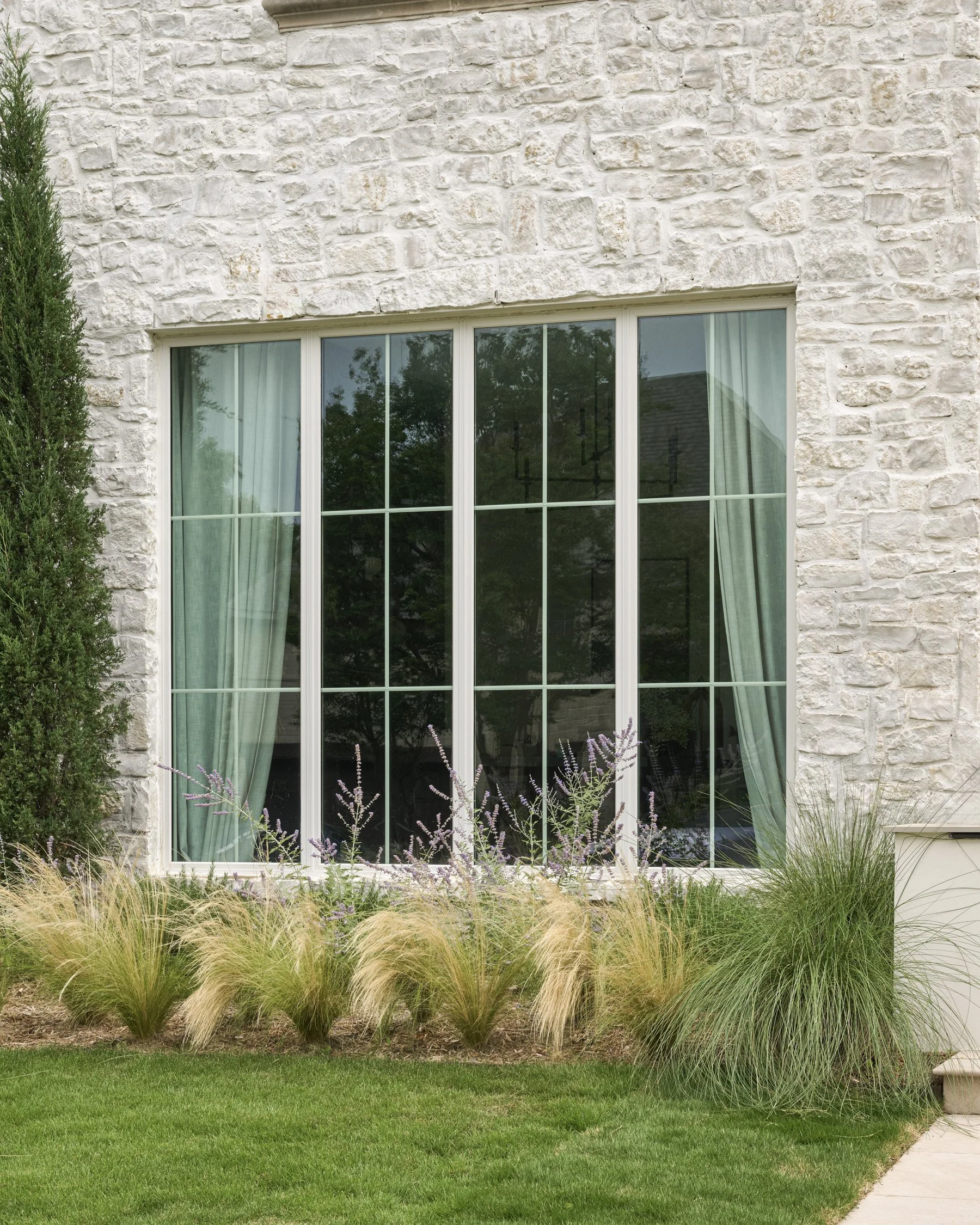 California-inspired front yard landscape with layered Ornamental Grasses in Dallas, TX | Designed by Caroline Higgins Design