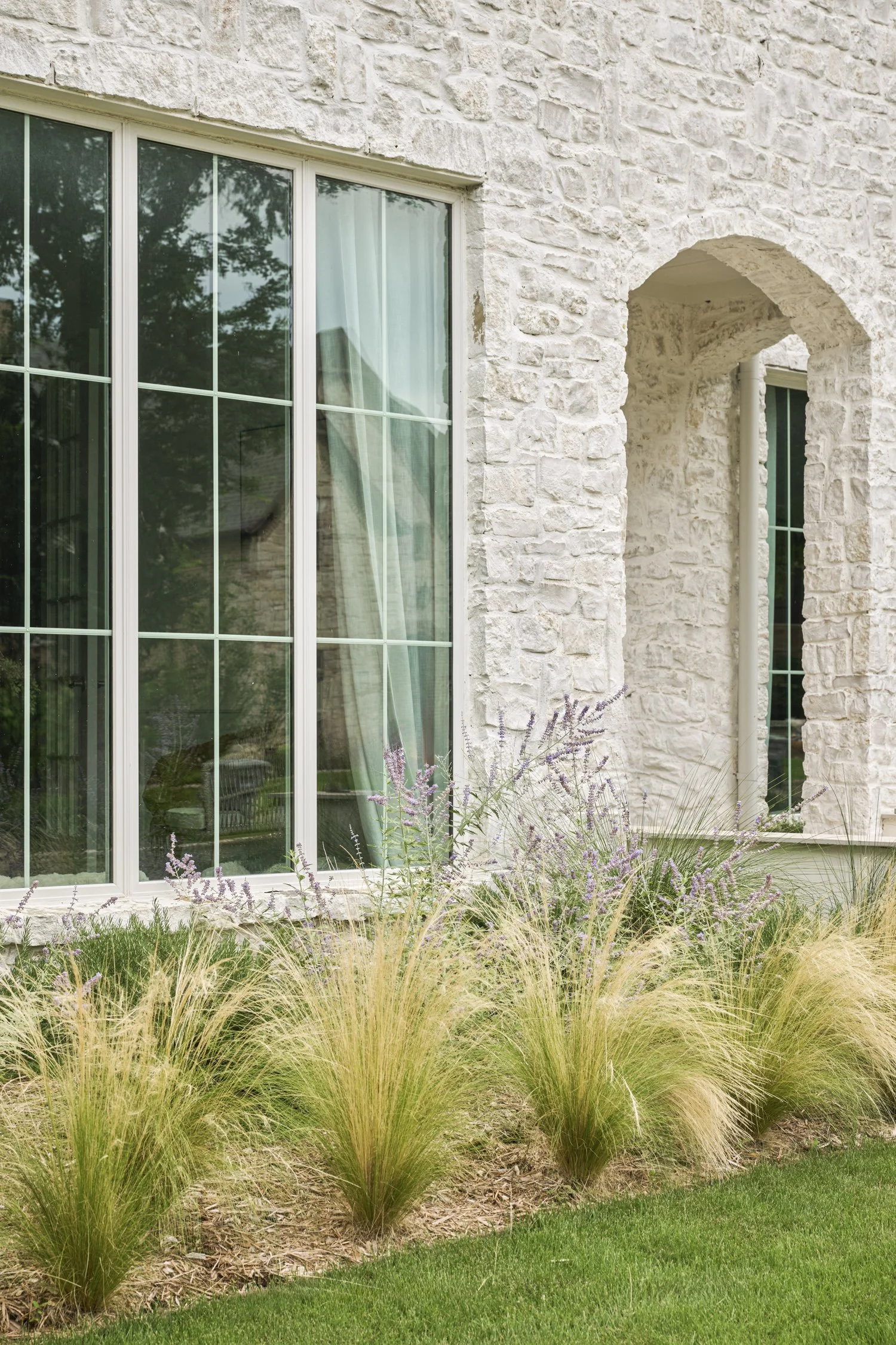 California-inspired front yard landscape with layered Ornamental Grasses in Dallas, TX | Designed by Caroline Higgins Design