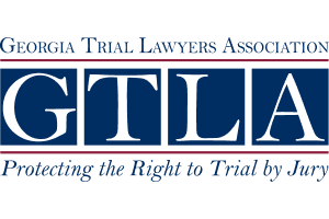 Logo of the Georgia Trial Lawyers Association with the acronym G.T.L.A. and the tagline 'Protecting the Right to Trial by Jury'.