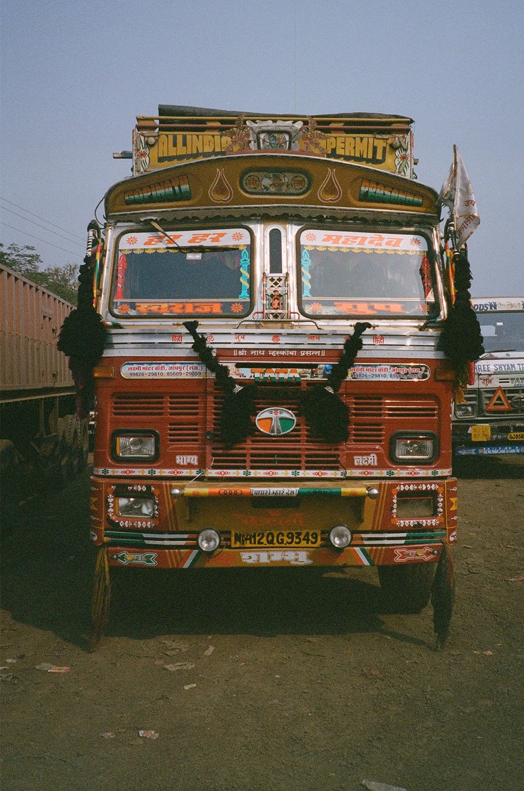 Colorful decorated truck parked outdoors with a clear sky background.