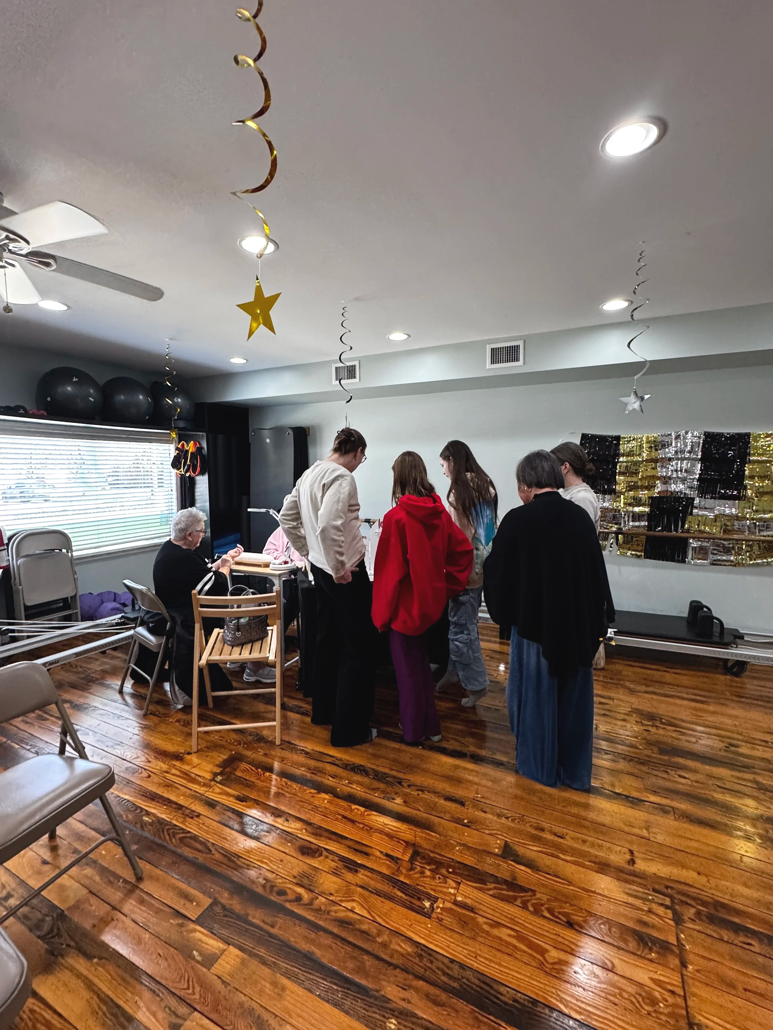 A group of people gathered around a table at Balanced Pilates and Wellness Boutique in Midland, Michigan.