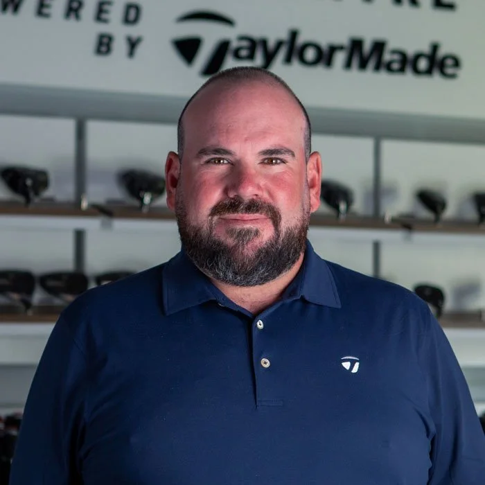 Fairview Mountain Golf Club head professional Rob Tadey smiling in the fitting bay.