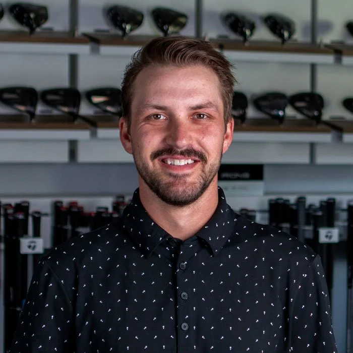 Fairview Mountain Golf Club associate professional Ryder Murray smiling in the fitting bay.