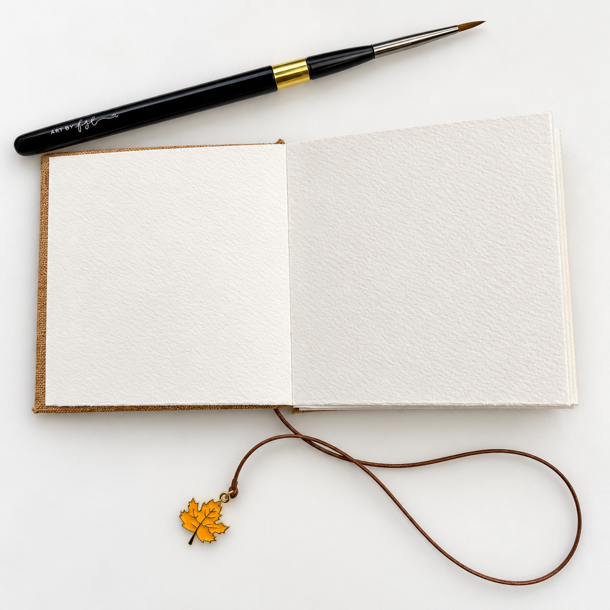 3. Blank visual diary with brush and charm.png