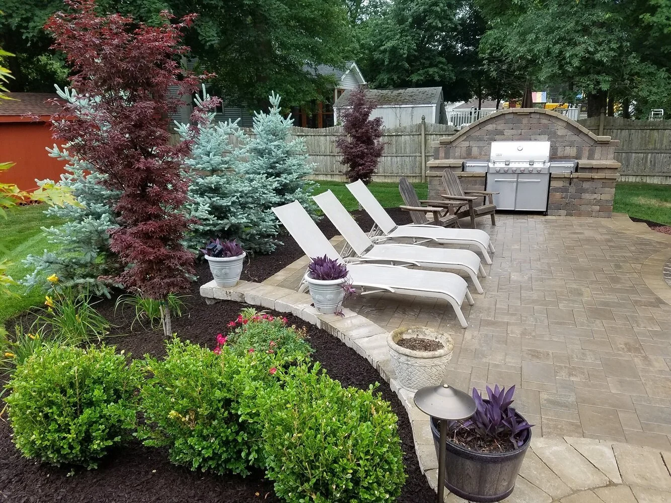 Transforming Millburn, NJ Outdoor Spaces: The Art of Blending an Outdoor Kitchen with Lush Plantings