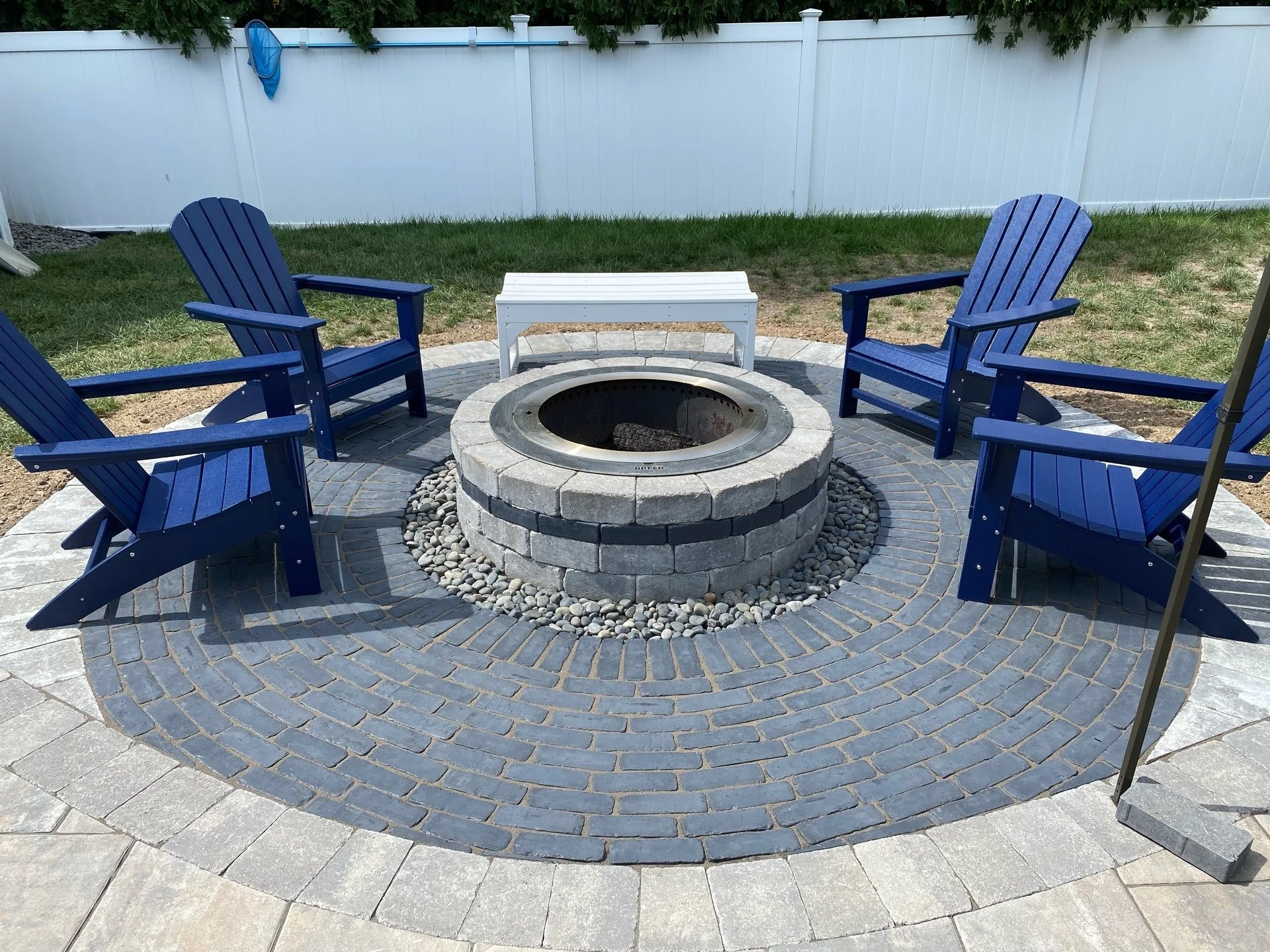 A custom fire pit installation process for a luxury backyard.  - Green Nature Landscape Design