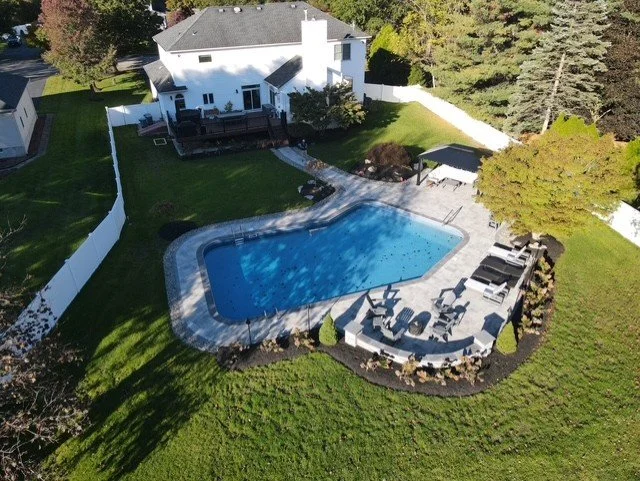 A professionally designed poolside outdoor kitchen and entertaining area in Ho-Ho-Kus, NJ