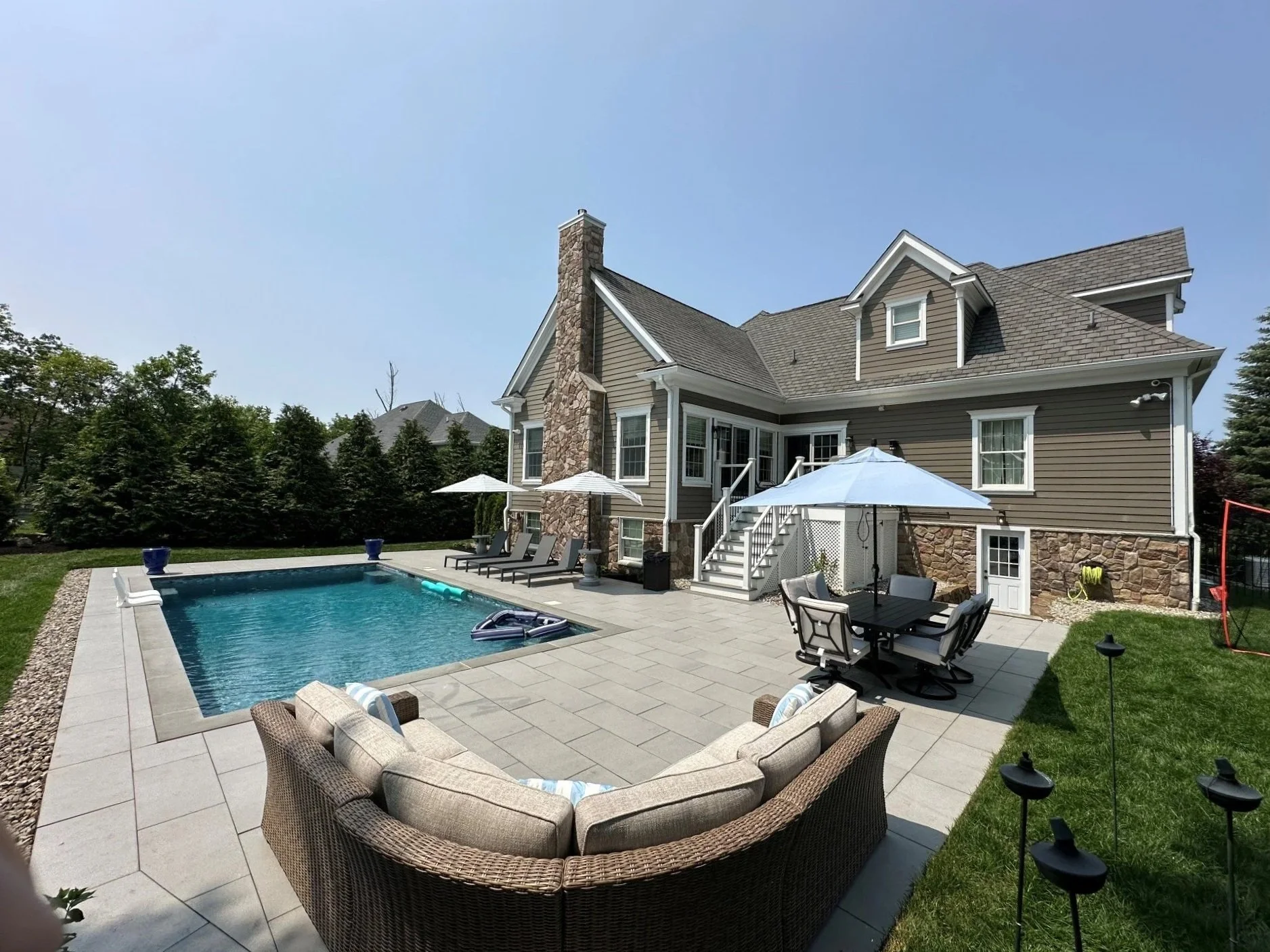 A premium outdoor living project featuring swimming pool landscaping.  - Green Nature Landscape Design