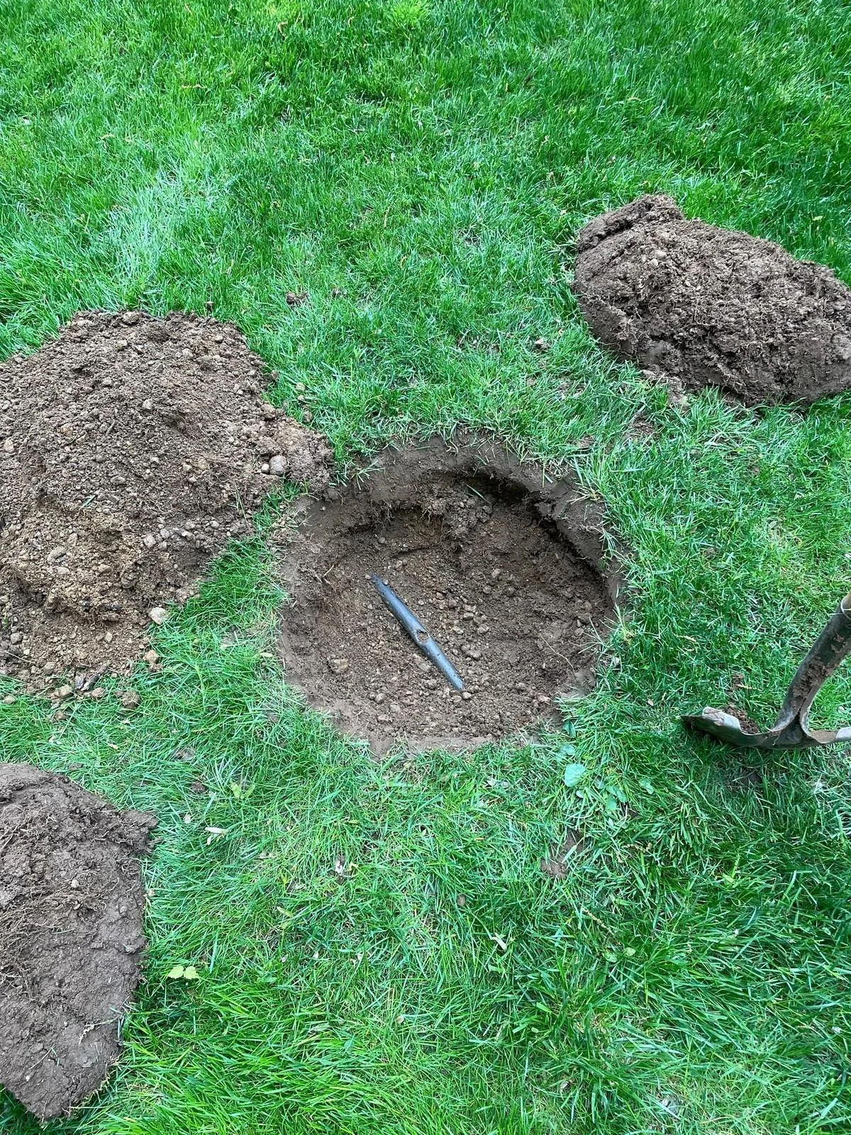 A sprinkler system repair being performed on a residential property. - Green Nature Landscape Design
