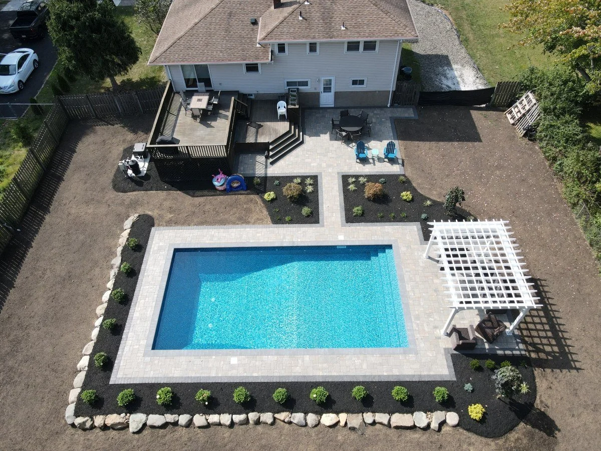 A pergola structure overlooking a swimming pool landscaping design. - Green Nature Landscape Design