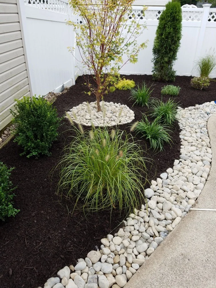 Landscape renovation featuring fresh plantings around a home's entry. - Green Nature Landscape Design