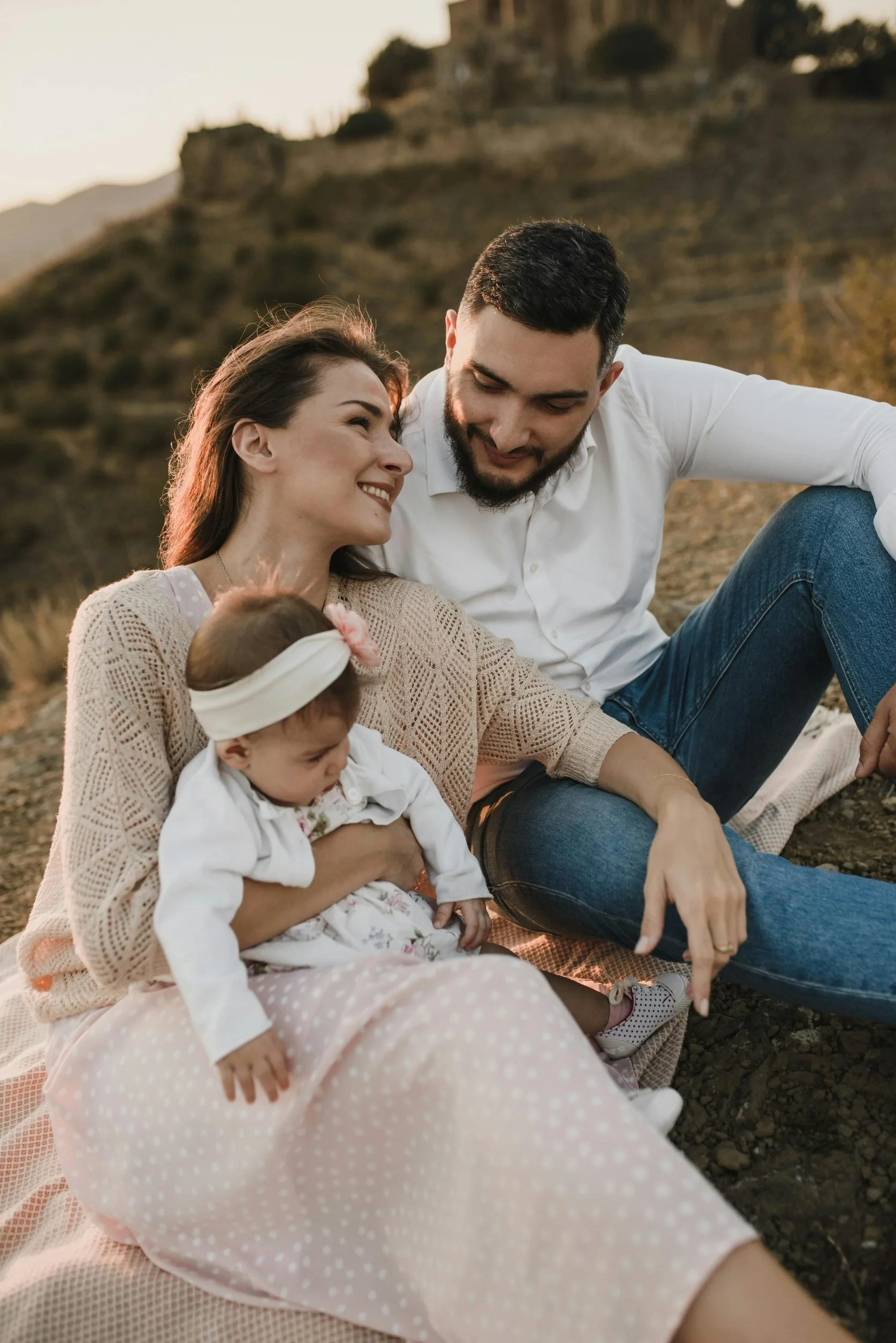 Two parents and a young child embracing together