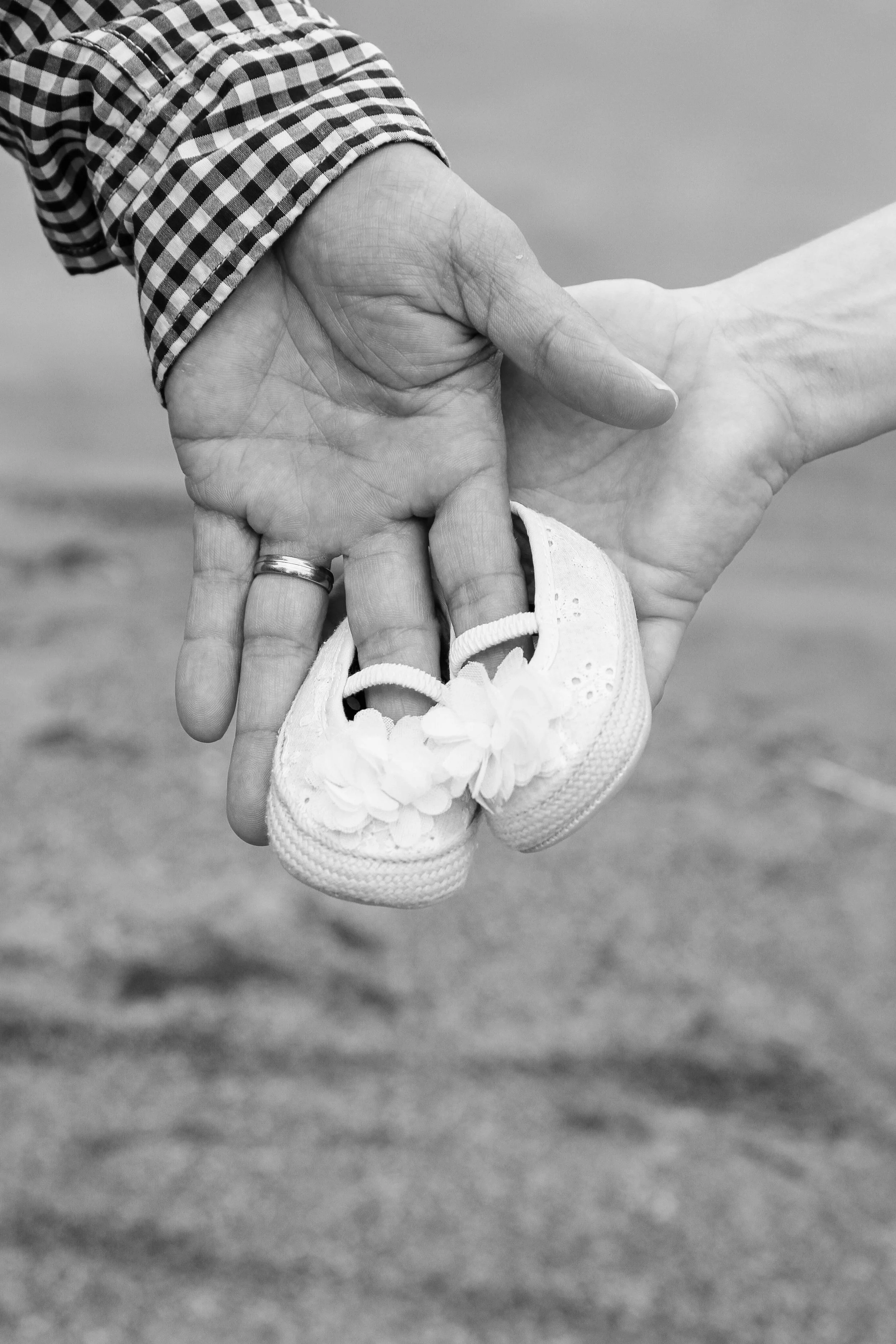 A woman breastfeeding a newborn baby indoors by a window.